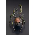 Collectible Handmade black spider sculpture with a rose and moss 